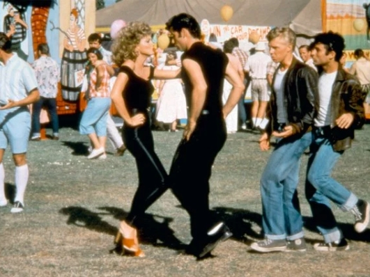 She famously had to be sewn into those pants, and now Olivia Newton-John’s iconic “Grease” costume has sold for a fortune and a good cause.