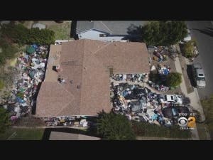 Neighbors say junk is dropped off and picked up through the night at this Granada Hills home.