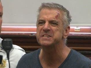 John Donovan shouts during his arraignment.