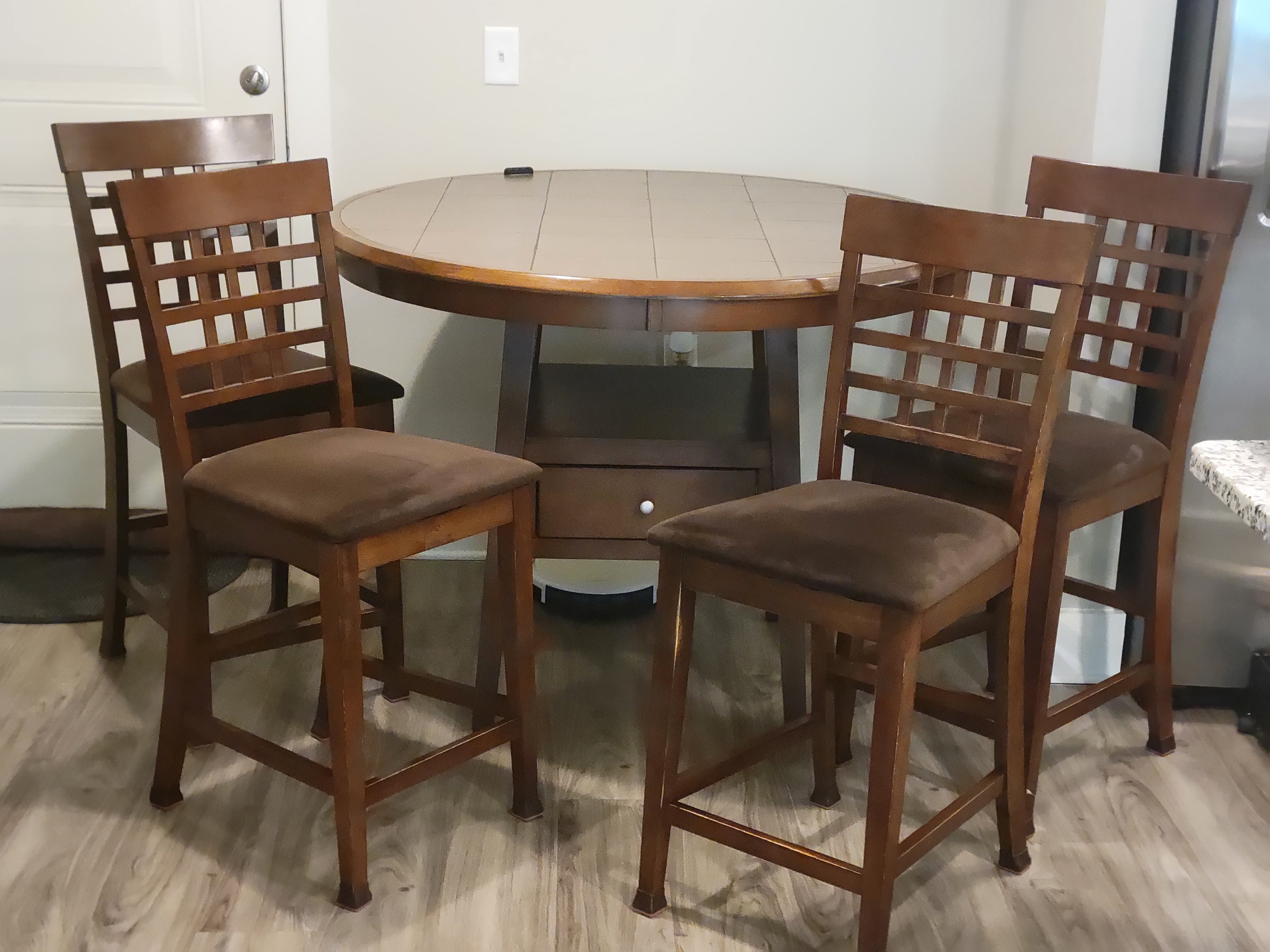 Beautiful Terra Tile high top table and four microfiber seats with crisscross stool backs.