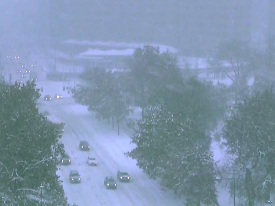 Snow falls in Denver’s Civic Center Park on Tuesday morning.