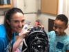 Lauren Duddy helps Daniel Saravia-Malena choose a backpack