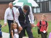 Farmingdale Superintendent Paul Defendini helps Woodward Parkway Elementary students off the bus on the first day of school.
