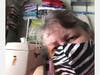 NSDAR member Laura Nygaard models one of the colorful masks she has made.