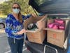 Service to Veterans Committee Chair April Hay loads boxes of Dopp Kits for delivery.