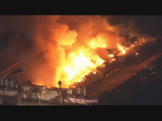 Crews battled the four-alarm fire all night and remained on scene Tuesday morning putting out hot spots.