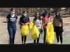 Girl Scout Troop #72401 holding full bags after collecting litter near Shawsheen Pre-school and playground. 