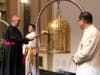 Bishop Camillo Ballin, Apostolic Vicar of Northern Arabia, left, rings the Bell of World Peace and Love during a gala dinner. The event was to celebrate the UN's designation of April 5 as the International Day of Conscience. 