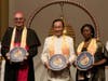Bishop Camillo Ballin, left, and Ambassador Youngor Telewoda of Liberia to Austria, right, are each presented with a compass clock of conscience by Dr. Hong, Tao-Tze, president of FOWPAL.