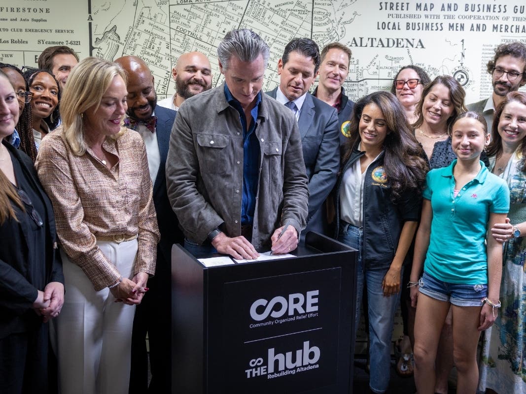 The governor signed the bills at a meeting with fire survivors, advocates, community leaders and the bill authors.
