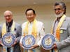 Dr. Hong, Tao-Tze, president of the Federation of World Peace and Love, center, presents the compass clock of conscience to Bahrain's Cabinet Affairs Minister Mohammed Bin Ibrahim Al Mutawa, left, and Shaikh Hussam bin Essa Al Khalifa, president of Prince