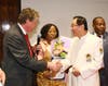 Dr. Hong, Tao-Tze, president of FOWPAL, right, is honored by Rhode Island Lieutenant Governor Daniel Mckee for fostering a culture of conscience, love, and peace at a gala dinner in New York, Feb. 19, 2020. (AP Images)