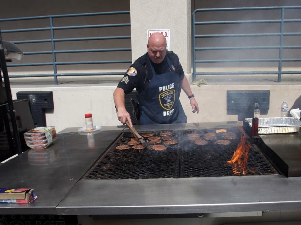 Pasadena Police Sergeant Chris Burchett grills hamburgers for the appreciation BBQ for the staff who worked "all hands on deck" for the last 2 months since the shut down due to the Covid-19 pandemic.