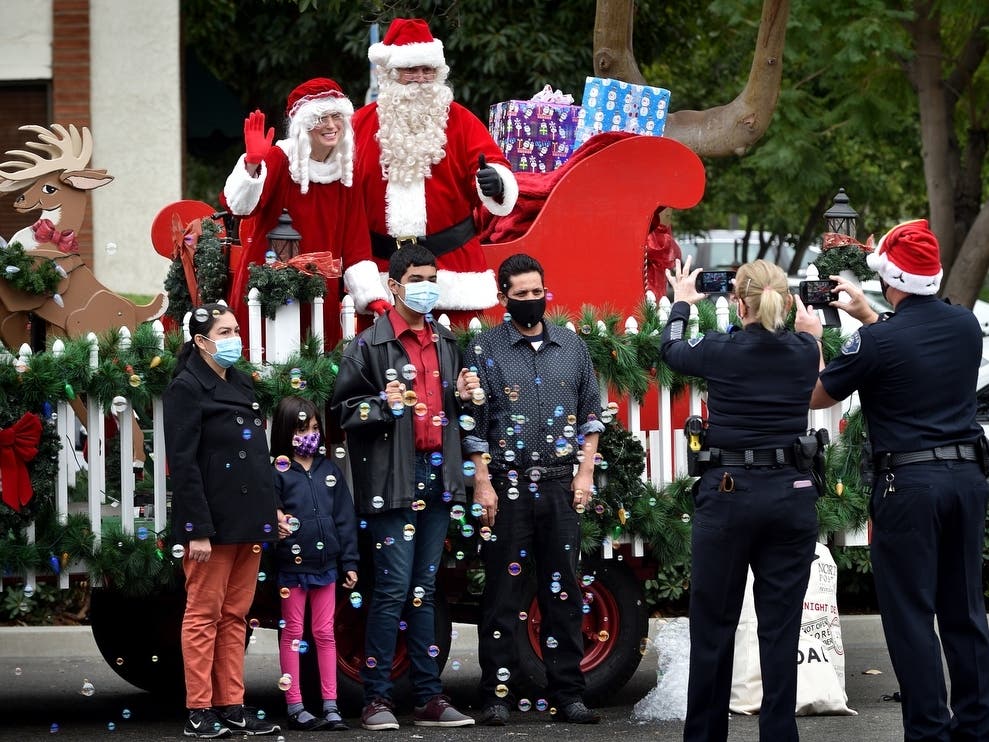 Tustin Police Department’s Santa Cop event, normally a dinner for families in need inside the Tustin Community Center, was held outdoors as 