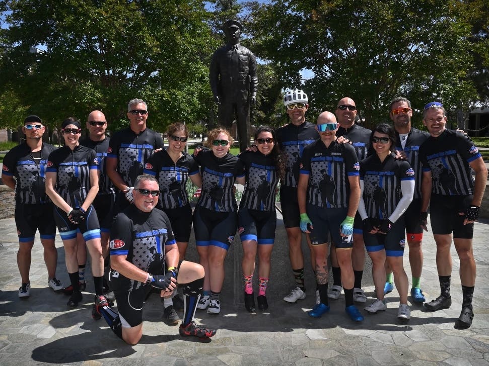 The Code 3 Cycling Team gathers in front of the Westminster Police Department's Officer's Memorial at the end of their bike ride from Sacramento to raise money for families of fallen officers. Photo by Steven Georges/Behind the Badge
