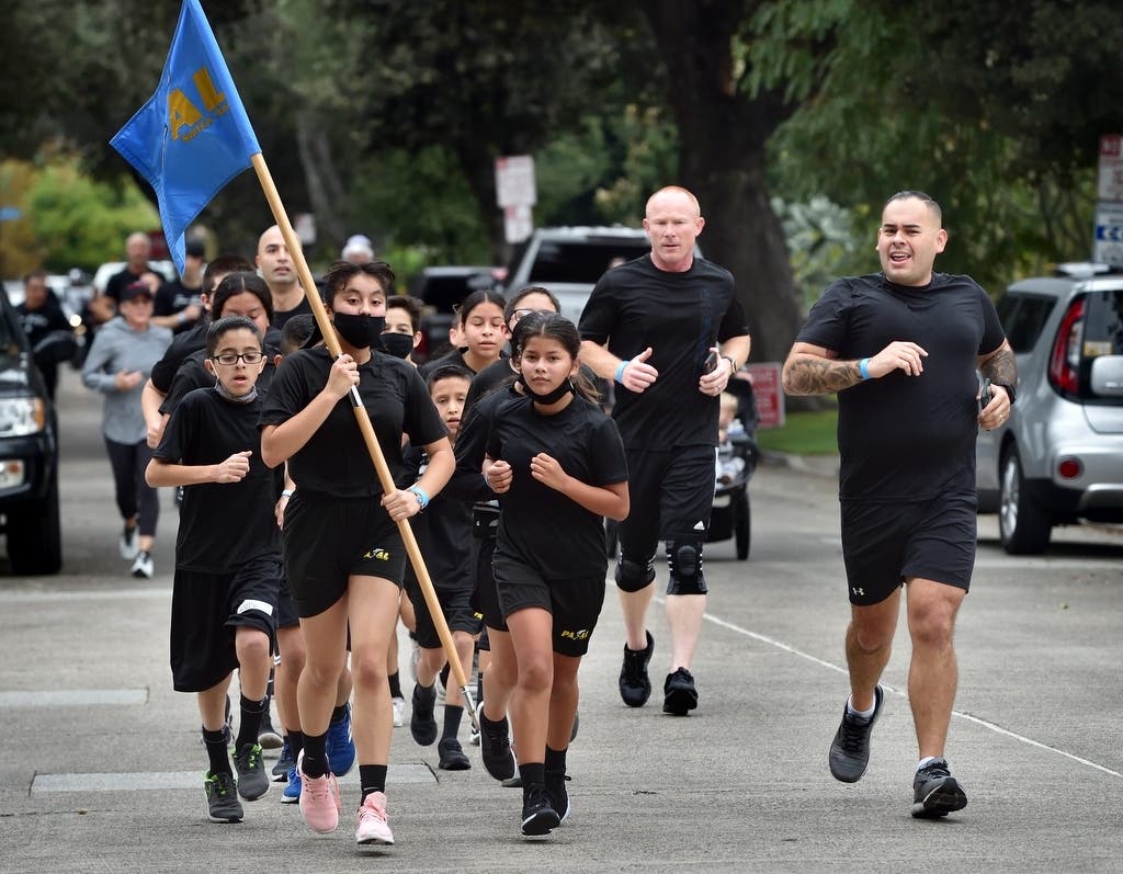 Runners make their way down Freeman Street during Santa Ana Police Department’s 5K Fun Run.