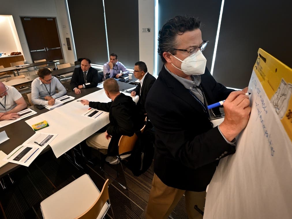 Patrick Johnson, OC Information Technology, jots down ideas from his group during the Orange County Cyber Disruption Resiliency Workshop. 