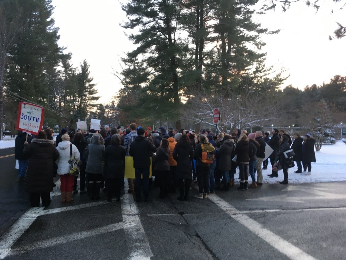 Dozens gathered outside the school at after the final bell, Wednesday.