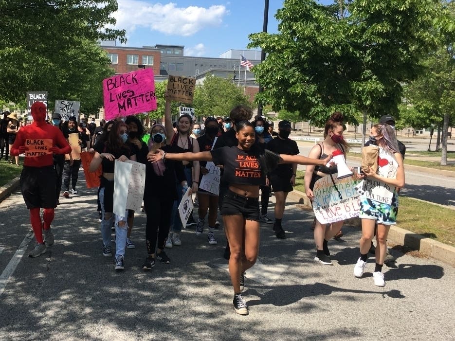 Brooklyn Manna, 18, leads demonstrators to Woburn City Hall at the rally in honor of George Floyd she organized.
