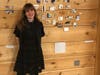 Shea Lord-Farmer poses with some of her artwork at her exhibit opening.