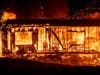 Flames consume a home as the Kincade Fire tears through the Jimtown community of Sonoma County, California on Thursday.