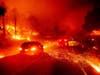 Embers fly across a roadway as the Kincade Fire burns through the Jimtown community of Sonoma County, California on Thursday.