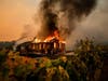 Vines surround a burning building as the Kincade Fire burns through the Jimtown community of unincorporated Sonoma County, Calif., on Thursday, Oct. 24, 2019.