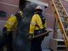 Firefighters open the door of a classroom that was impacted from flames on the roof during the Tick fire in the Santa Clarita area of Los Angeles, Calif. on Thursday, Oct. 24, 2019