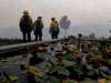 Firefighters watch as the Getty fire burns around them on Monday in Los Angeles.