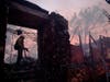 A firefighter hoses down a smoldering home destroyed by the Getty fire on Monday in Los Angeles.