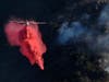 A plane drops fire retardant to prevent the Getty fire from spreading further on Monday in Los Angeles.