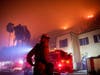 A firefighter watches a flames approach the Mandeville Canyon neighborhood during the Getty fire on Monday in Los Angeles.