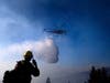 A helicopter drops water while battling the Kincade Fire near Healdsburg, Calif., on Tuesday, Oct. 29, 2019. 