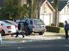 Fresno police investigators work the driveway where a shooting took place at a house party which involved multiple fatalities and injuries i
