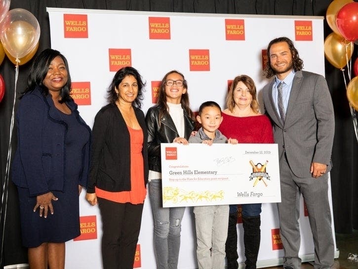 Ethan Chen, Cezanne Flowers, Alyssa Peñas and Usha Ranji accept a grant for Green Hills Elementary in Millbrae, presented by Giants shortstop Brandon Crawford.