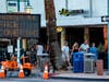 Pedestrians ignore the mandatory face coverings order while walking in downtown Palm Springs on July 16, 2020 in Riverside County, California. Riverside County is experiencing a surge in COVID-19 cases.