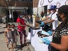 L-R: Exonerated Five Member Korey Wise, Congressman Adriano Espaillat and City Councilmember Bill Perkins helped give away school supplies and backpacks in Schomburg Plaza on Thursday, Aug. 20, 2020.