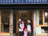 Nick Larsen (left) and Petrushka Bazin Larsen with two of their children in front of the original Sugar Hill Creamery location near Marcus Garvey Park.