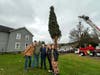 Tree donor Al Dick poses with his family in front of the tree in Oneonta, NY before it is cut down on Nov. 12, 2020.