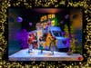 One of this year's window displays shows a celebration around a neighborhood food truck at a holiday block party.