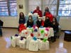 Manhattan Borough President Gale Brewer (center, wearing Santa hat) and P.S. 76 Principal Charles DeBerry (back left) at Monday's toy donation.