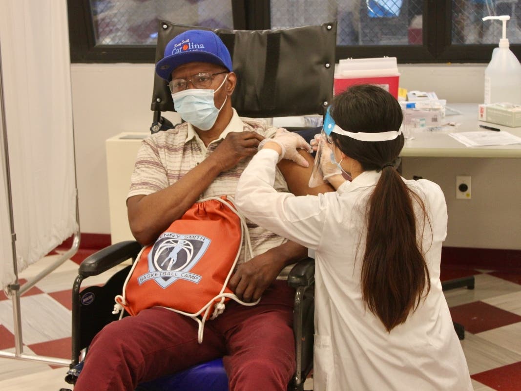 Samuel Gelzer, 66, a resident of Harlem Nursing and Rehabilitation, gets the coronavirus vaccine on Jan. 15, 2021.