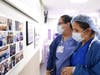 Lenox Hill Hospital employees look at a new Healthcare Heroes Wall unveiled at the hospital on Monday.