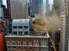 Video from the scene showed firefighters breaking windows on a penthouse structure atop the brick building at 100 West 58th St.