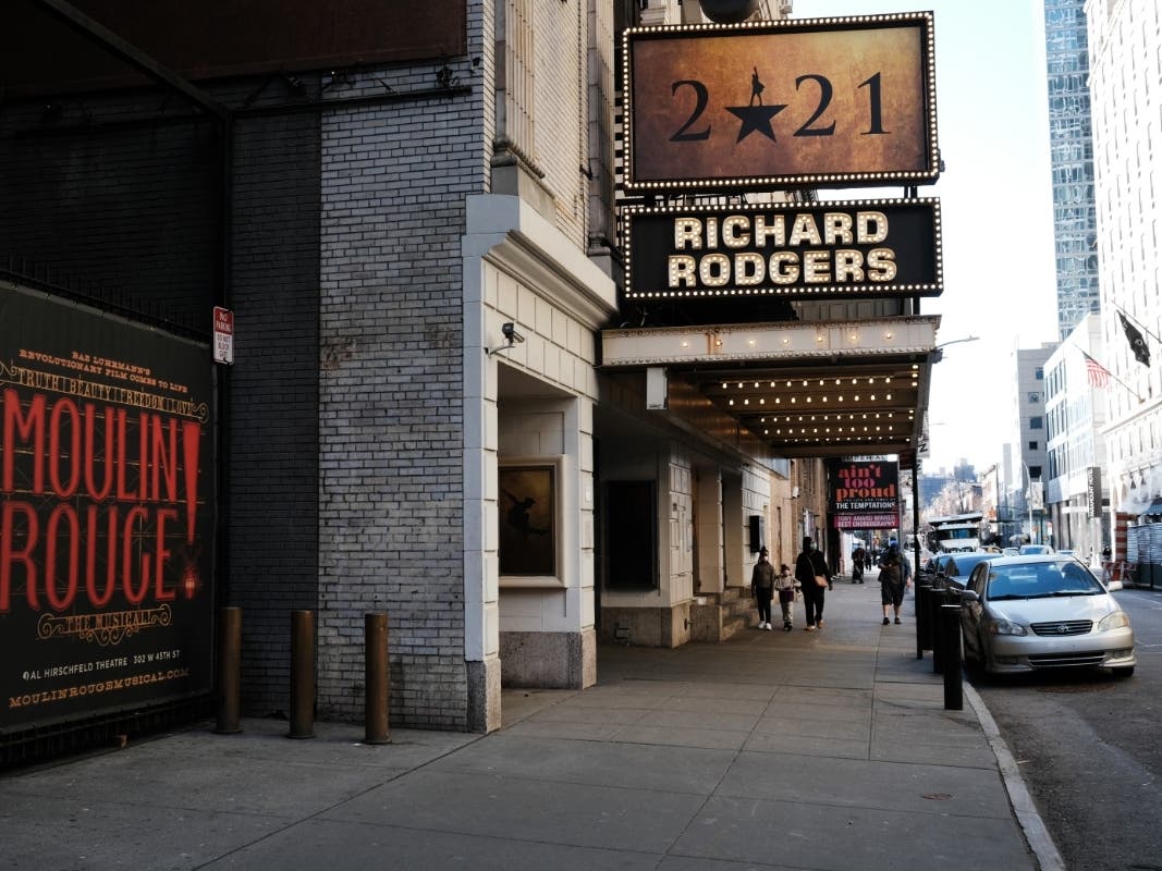 People walk through the empty Broadway theater district one year after it was closed due to Covid-19 restrictions on March 12, 2021 in New York City.