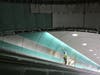 A worker installs tiles over an escalator in the future Long Island Railroad concourse at Grand Central Terminal, May 5, 2021.