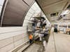 Workers install tiles on the tunnel walls at a platform in the future Long Island Railroad concourse at Grand Central Terminal, April 7, 2021.