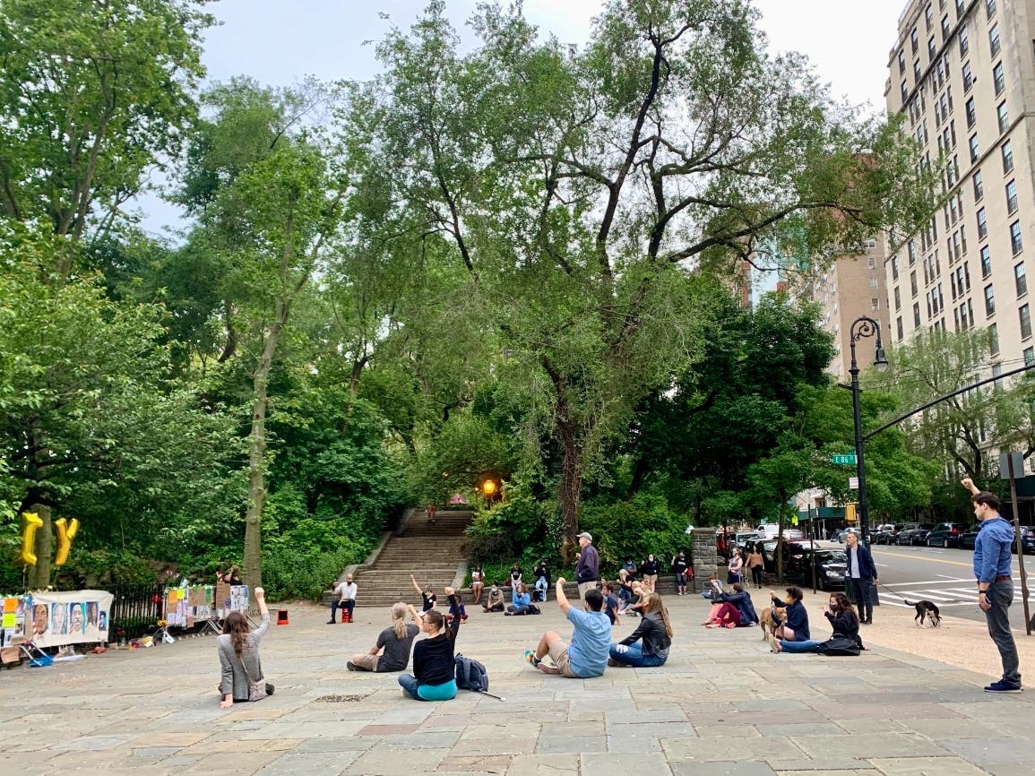 People gathered in Carl Schurz Park on Wednesday for the nightly UES for Black Lives Matter vigil. Birthday balloons on the left denoted the vigils' one-year anniversary.