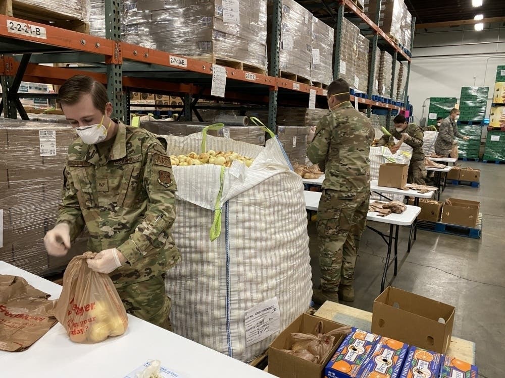 Airmen from the 141st Air Refueling Wing and the 242nd Combat Communications Squadron assist in packaging and distributing food Monday at Second Harvest Inland Northwest in Spokane, Washington.