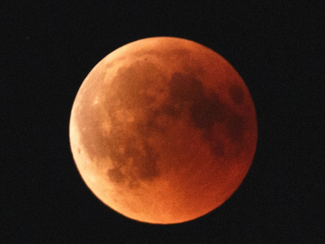 A lunar eclipse occurs when the Earth comes between the sun and the moon, blocking the sunlight from falling on the moon, which takes on a dark reddish or blood color.